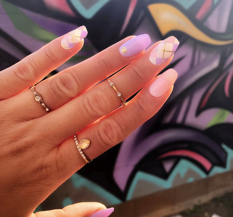 pastel purple and pink nails with argyle accent nail